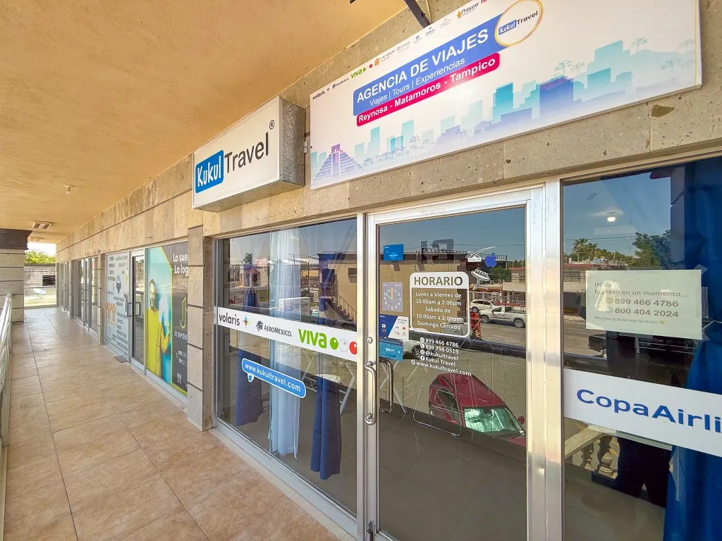 Fachada de Kukul Travel en plaza comercial de Reynosa con horario en puerta